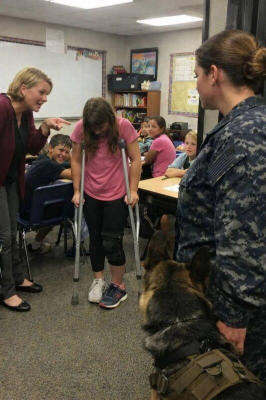 La Preside Prese il Telefono con Calma e Chiamò la Sicurezza per Quello che Descrisse come un “Confronto con un Genitore” — Ma Ciò che una Tenente Comandante della Marina e il Suo Silenzioso Pastore Tedesco Stava per Rivelare all’Interno di Quella Classe Quarta Era Qualcosa che Nessuno Era Preparato a Spiegare